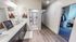 Bright and inviting bathroom with sleek double-sink vanity, modern shower, and adjoining cozy bedroom featuring stylish decor.