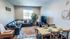 Inviting living room with modern decor, cozy leather sectional, stylish dining set, and bright window view.