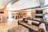 Luxurious open-concept living area with modern kitchen, cozy fireplaces, and stylish seating. Perfect for entertaining.