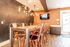 Chic dining area with modern copper chairs, a wooden table, and ambient lighting creating a warm, inviting atmosphere.