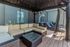 Chic outdoor patio featuring elegant wicker furniture, a comfy sectional couch, and modern lounge chairs for relaxation under a stylish canopy.