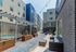 Modern apartment complex courtyard featuring stylish outdoor lounge seating, vibrant planters, and a sparkling pool for ultimate relaxation.