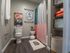 Charming bathroom with modern decor featuring a vibrant shower curtain and elegant artwork.
