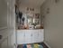 Charming bathroom featuring elegant decor, a cozy countertop with modern fixtures, and vibrant wall art for a touch of style.
