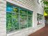 Charming building exterior with vibrant mural of Spinner Place, featuring colorful local landmarks and scenic details, ideal for urban living.