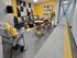 Modern lounge area with stylish gray sofas, sleek black and white geometric wall art, and vibrant yellow accents, creating a welcoming atmosphere in a contemporary apartment complex.