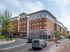 Elegant brick apartment complex with modern architecture, featuring multiple floors and convenient city access.
