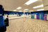 Spacious, well-lit fitness studio with mirrored walls and exercise equipment, perfect for workouts and group classes.