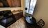 Charming kitchen nook featuring elegant dark wood cabinets, granite countertops, and a cozy dining area with a scenic view.