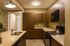 Modern kitchen with elegant granite countertops, rich wooden cabinets, and sleek appliances including a stove and built-in microwave.