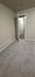 Inviting room with plush carpet, neutral walls, and open doorway leading to a well-lit hallway, perfect for personalized modern living.
