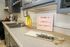 Contemporary kitchen with sleek gray cabinetry, chic countertop decor, and a sign welcoming you to Liberty, exuding a warm, modern vibe.