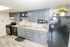 Charming and modern kitchen with sleek gray cabinets, stainless steel appliances, and inviting decor.