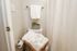 Bright and cozy bathroom with fresh white towels and a decorative potted plant.