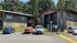 Charming apartment complex surrounded by lush greenery with convenient parking, showcasing a tranquil living environment.
