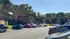 Charming apartment complex surrounded by lush greenery, ample parking, and a sunny, tranquil environment.