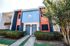 Charming duplex with vibrant exterior, featuring modern design elements, private entrances, and lush greenery.