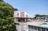 Charming modern apartment complex with vibrant exterior and inviting pool area, perfect for relaxation and leisure.