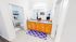 Elegant bathroom featuring dual sinks, granite countertops, and a spacious vanity area with ample storage and stylish decor.