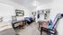 Bright and cozy student bedroom featuring two twin beds, stylish desks, and ample natural light, ideal for comfortable and focused study sessions.