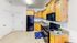 Modern kitchen with elegant wooden cabinets, sleek black appliances, and polished granite countertops, exuding warmth and sophistication.