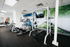 Modern apartment gym with state-of-the-art exercise equipment and vibrant wall art, perfect for an energizing workout.