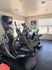 Bright and inviting apartment fitness room with modern exercise equipment and large windows for natural light.