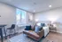 Modern studio apartment with cozy living area and stylish furnishings.