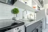 Modern kitchen with stainless steel appliances, elegant countertops, and minimalist shelving.