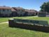 Exterior view of Canterbury Village showing multiple apartment buildings with well-maintained green lawns.