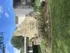 Inviting exterior view of Indian Guide Terrace Apartments with stone signage and lush landscaping.
