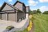 Modern townhouse exterior, private attached garage, and lush green landscape creating inviting curb appeal.