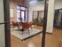 Modern meeting room with elegant leather chairs, a stylish round table, and chic exposed brick walls for a contemporary vibe.