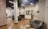 Chic open-concept lounge with modern decor, cozy seating, and stylish exposed brick walls.