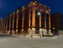 Stunning brick building with warm architectural lighting against a twilight sky, offering urban elegance and charm.