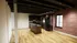 Chic modern kitchen with dark wood cabinetry, granite countertops, and exposed brick accent wall.
