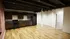 Chic open-plan kitchen with dark wood cabinets, modern appliances, and stunning hardwood floors in a spacious apartment.
