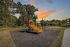 Charming playground with vibrant slide set against a picturesque sunset backdrop and lush greenery, ideal for family fun.