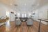 Modern open-concept living room with stylish furniture, hardwood floors, and abundant natural light, offering a welcoming atmosphere.