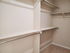 Spacious walk-in closet with multiple shelves and hanging rods, perfect for organized storage.