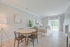 Bright, modern living and dining area with elegant decor, large windows, and tasteful furnishings offering a serene ambiance.