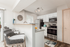 Bright and modern kitchen with sleek appliances and stylish breakfast bar seating, perfect for entertaining.