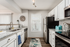 Modern kitchen with sleek granite countertops, stainless steel appliances, and elegant white cabinetry, exuding sophistication and style.