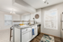 Modern kitchen with sleek granite countertops, stainless steel appliances, and abundant natural light, ideal for entertaining.