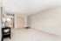 Inviting apartment entryway with plush carpet, warm lighting, and stylish decor enhancing a spacious, welcoming atmosphere.