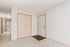 Inviting entryway with warm neutral tones, highlighting a spacious hallway and built-in closet. Bright and airy atmosphere enhanced by natural light from adjacent rooms.