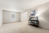 Inviting living room with plush carpet, modern decor, and flawless natural light from large window.