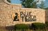 Inviting entrance sign for Blue Heron Pointe with beautifully landscaped greenery and elegant stonework.