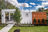 Modern and stylish poolside lounge with sleek design, lush green landscaping, and inviting outdoor seating area.