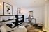 Chic home office space featuring modern artwork, stylish shelving, sleek desk, and elegant decor.